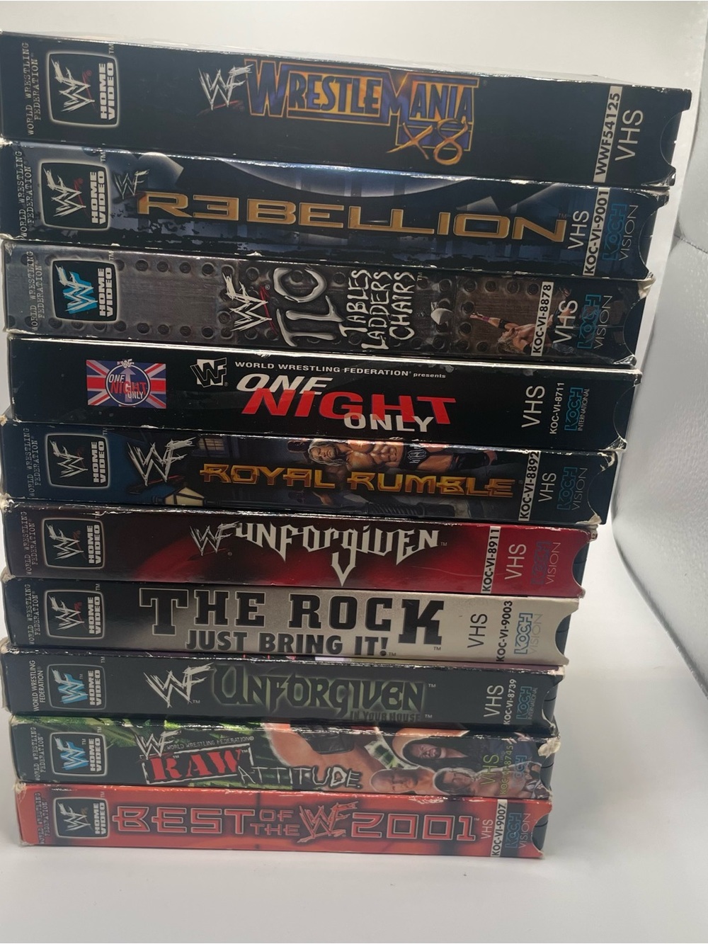 WWE VHS Collection Stack – Black, Red, Blue, Gold Spines